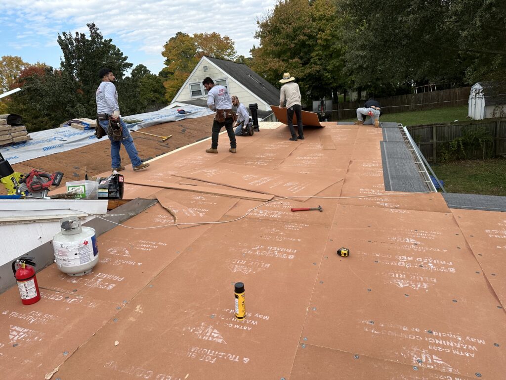 Hernandez Roofing Pros crew working across a prepared roof deck during a replacement