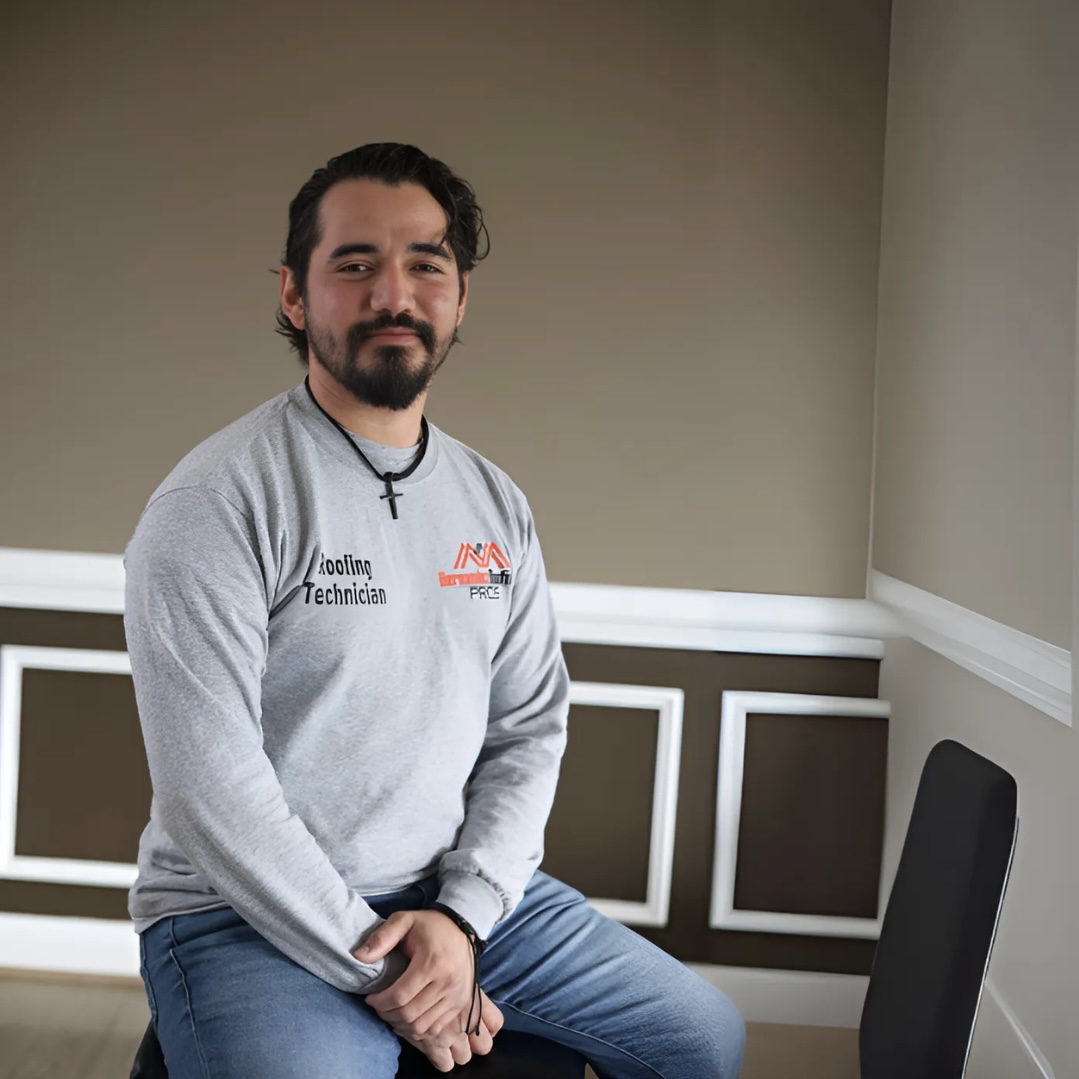 Hernandez Roofing Pros roofing technician in a branded company shirt