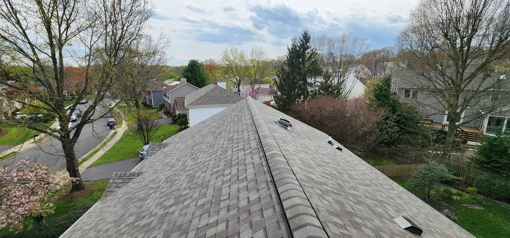 View along a completed roof ridge with the surrounding neighborhood beyond