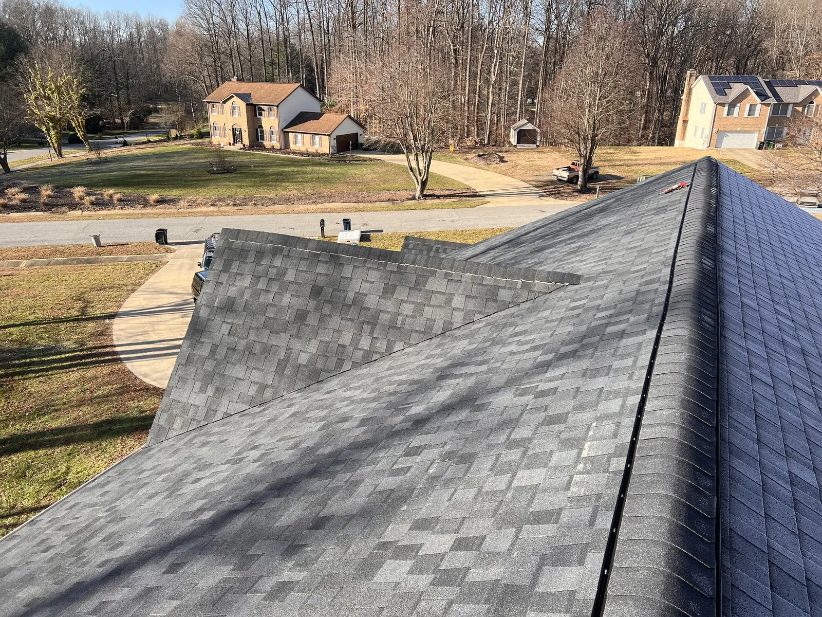 Completed shingle roof plane in Olney, Maryland with the surrounding neighborhood beyond