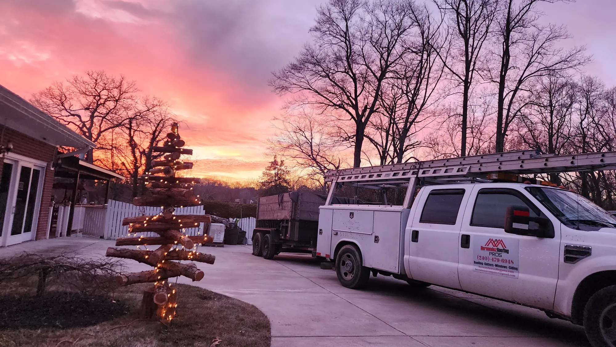 Hernandez Roofing Pros service truck photographed at dusk under a pink and orange sky